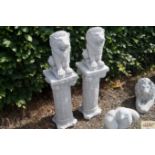 A pair of concrete garden ornaments in the form of