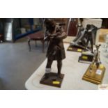 A vintage spelter figure of a girl with a cat