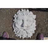 A garden wall plaque water feature of a Green Man