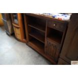 An Old Charm bookcase fitted with a linen fold dec