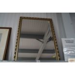 A modern gilt framed bevelled edge wall mirror