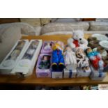 A collection of dolls and soft toys