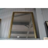 A framed bevelled edge wall mirror