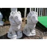 A pair of concrete ornaments in the form of lions