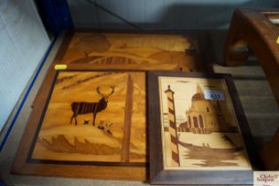 Three wooden wall plaques