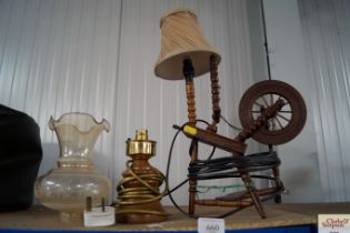 A table lamp in the form of a spinning wheel and o