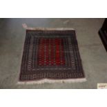 An approx. 3'2" x 2'7" patterned rug