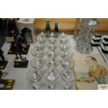 A quantity of Babycham glasses and two bottles of