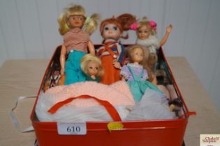A tin containing various dolls