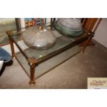 A heavy brass and plate glass two tier coffee tabl