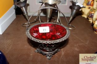 A plated and ruby glass swing handled sugar basket