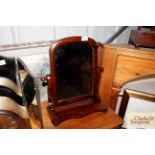 A mahogany swing framed toilet mirror