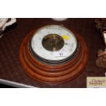 A circular oak cased barometer