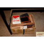 A box containing camera cases, manuals etc.