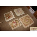 Three tapestry cushions and one tapestry cushion c