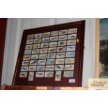 A framed collection of cigarette cards depicting v