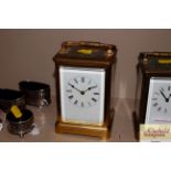 A brass cased striking carriage clock complete with key