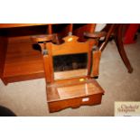 An early 20th Century oak mirrored wall shelf