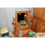 A stripped pine swing toilet mirror