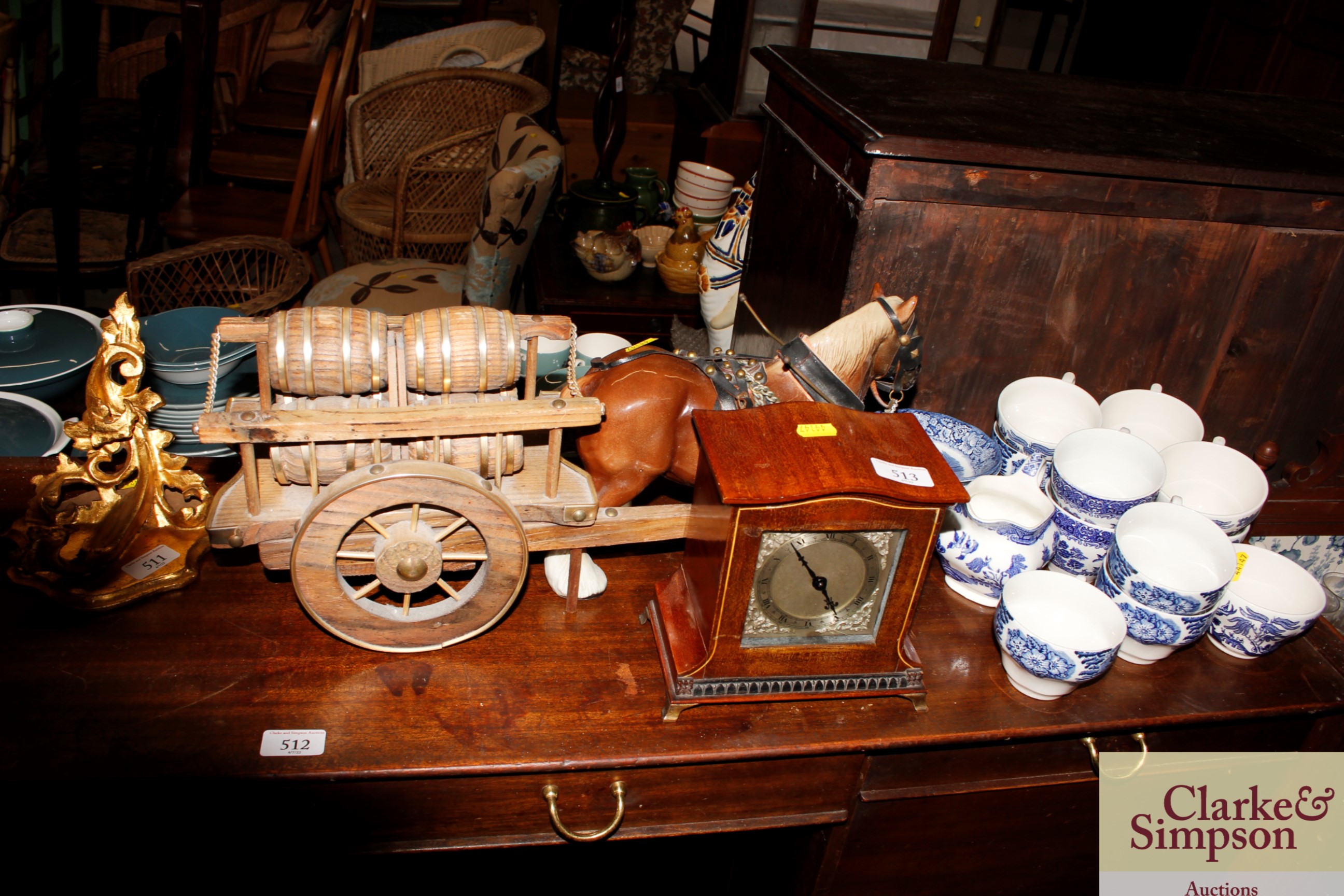 A mantel timepiece and a pottery model dray horse and cart