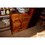 A pair of stripped pine bedside cabinets