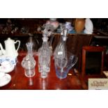 A collection of various glass decanters and other