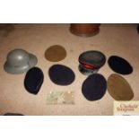 A WW2 helmet, various military berets and an Offic