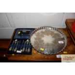 A circular plated drinks tray; a cased set of plat