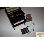 A musical trinket box in the form of a piano and a