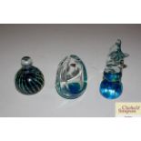 Three Mdina glass paperweights