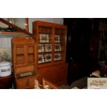 An early 20th Century golden oak bookcase, the upp