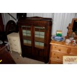 A 1930's oak leaded glazed and linen fold panelled