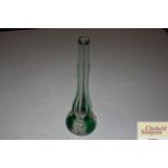 A green tinted glass vase with silver collar