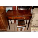 A 19th Century mahogany fold over tea table fitted