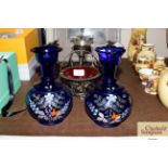 A pair of blue glass and enamelled baluster vases