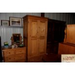 A stripped pine wardrobe fitted single drawer to b