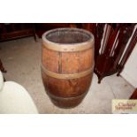 A wooden and brass bound barrel stick stand