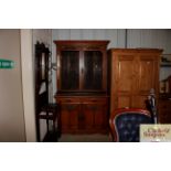 A late Victorian oak bookcase with glazed top and