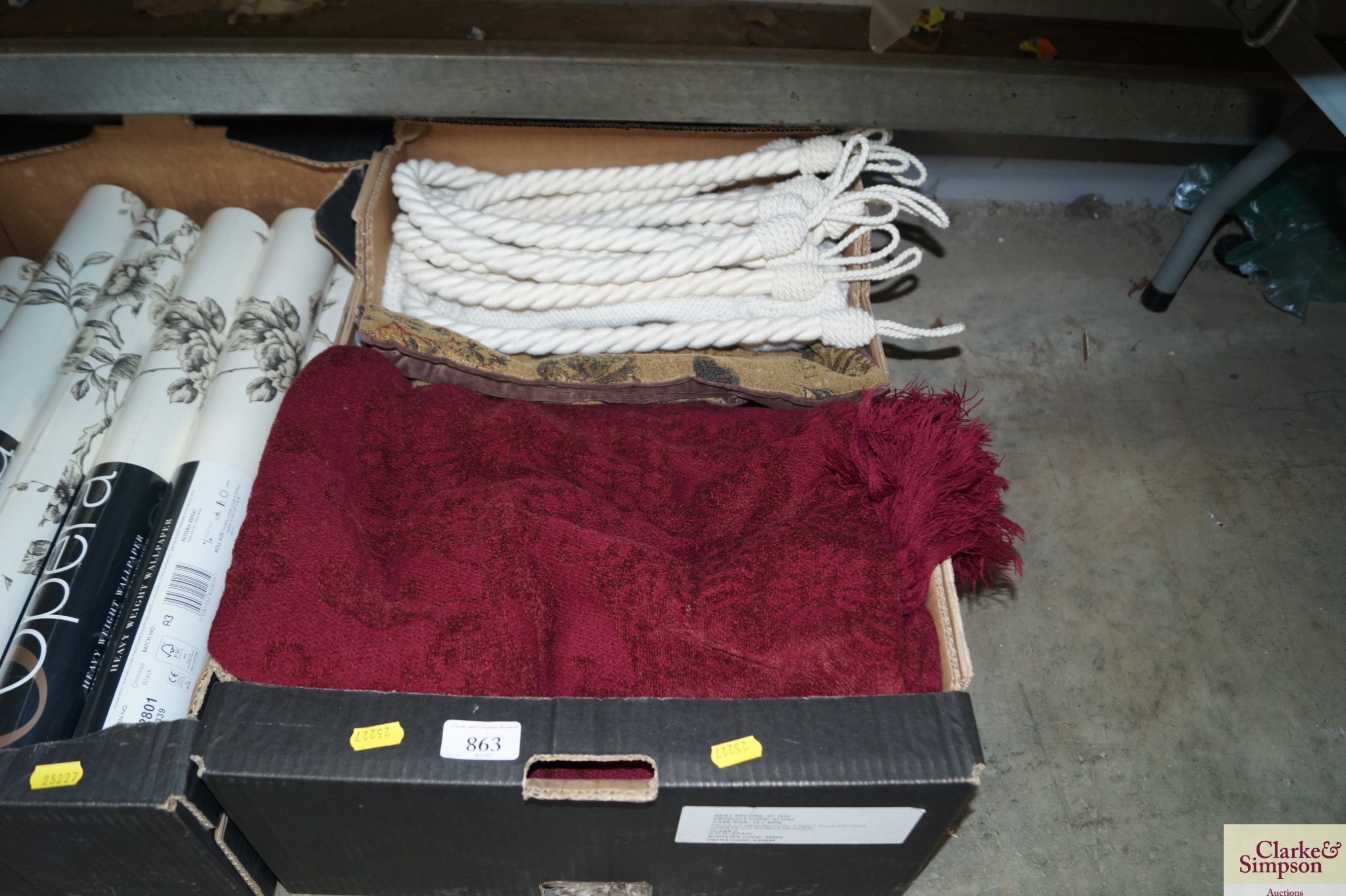 A box containing various cushion covers; curtain t