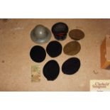 A WW2 helmet; various military berets and an offic