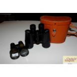 A pair of modern leather cased binoculars; and a p