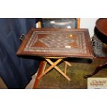 A carved oak tea tray and a folding stool