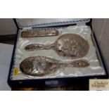 A cased silver backed dressing table set with cher