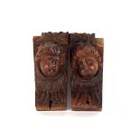 A pair of 17th Century carved walnut Putti terminals, 17cm