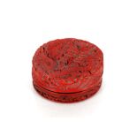 A Chinese cinnabar lacquered circular box and cover, decorated in relief with a dragon and similar