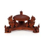 A late 19th Century Chinese carved wooden vase stand, decorated with peacocks and all over