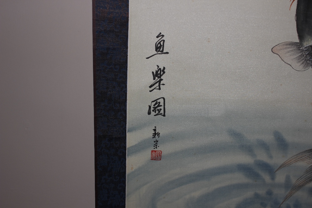 An Oriental painting on silk, depicting a leaping fish and two further fish below with signature and - Image 4 of 4