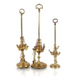 Three brass Eastern oil lamps, with loop carrying handles, fitted with wick trimmers on chains