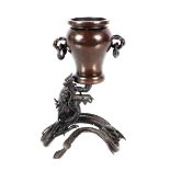 A 19th Century Chinese bronze vase, having rope twist handles supported by a coiled dragon, 17.5cm