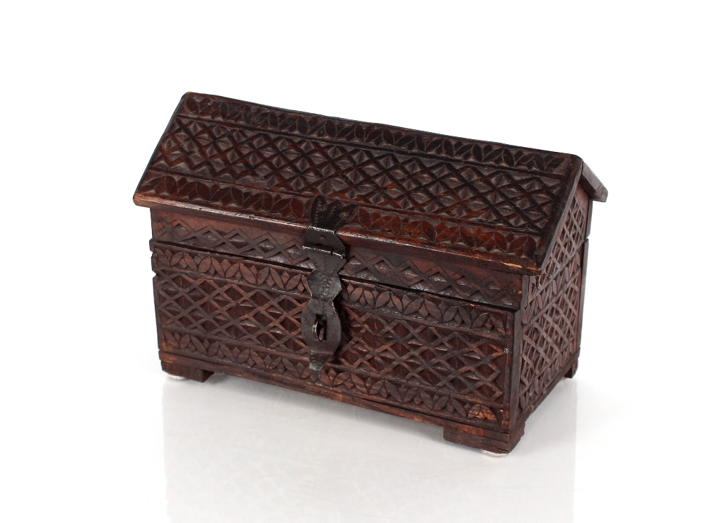 An Oriental carved wooden ark, with hinged angle lid and all over lozenge devices, 30cm